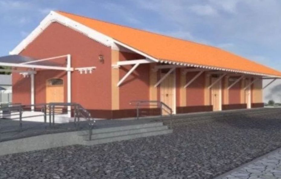 Ilustração digital da Estação Ferroviária de Ipiabas apresentando um prédio de arquitetura colonial na cor terracota com detalhes em bege e telhado cerâmico alaranjado sob um céu claro.